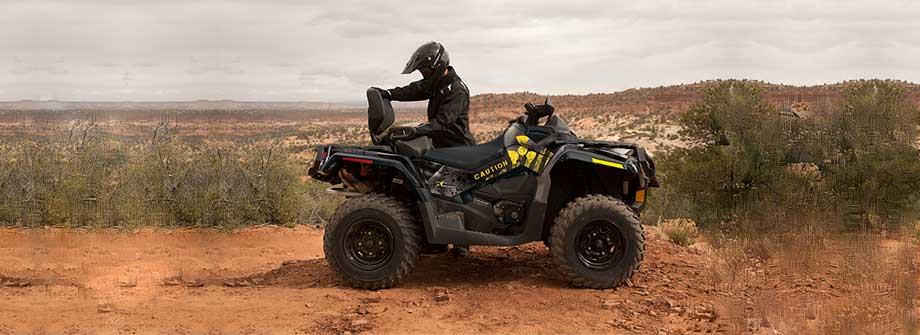 Sport ATV wearing a full Red Line graphic kit on a dirt trail