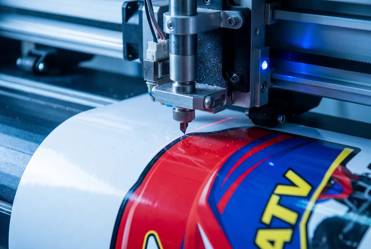 Computerized plotter blade contour-cutting printed ATV decal shapes